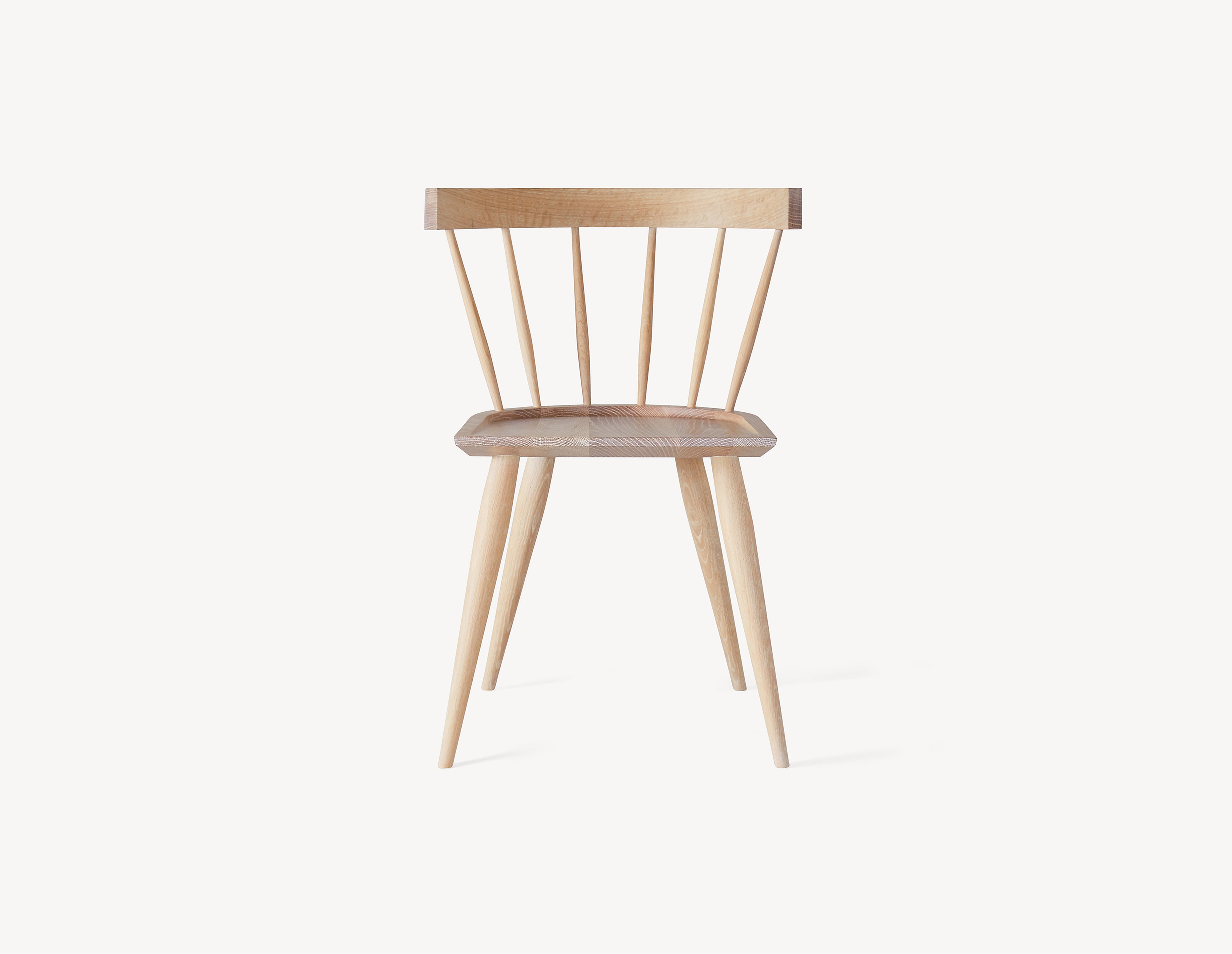 minimal wooden windsor dining chair in light white oak wood.