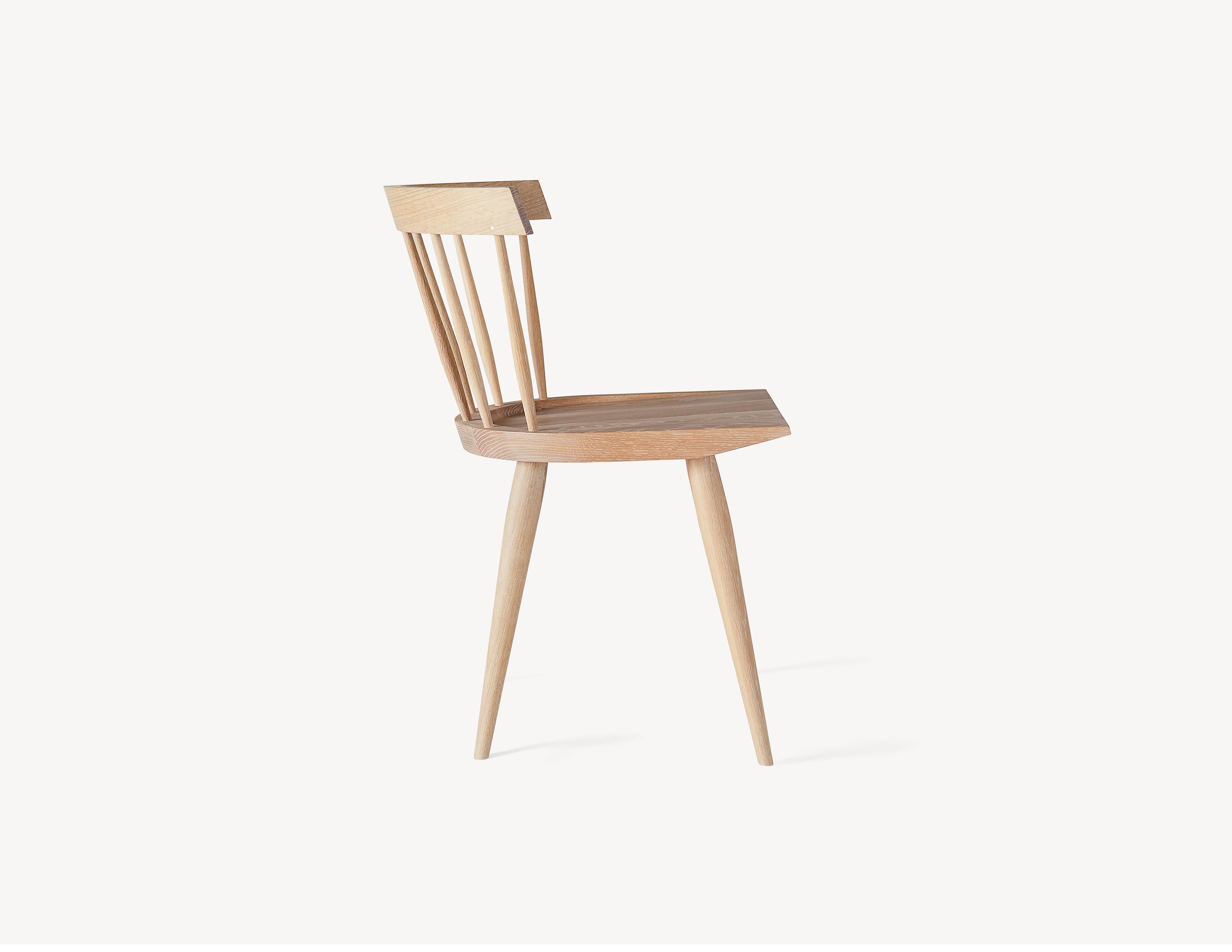 side view of minimal white oak windsor dining chair.