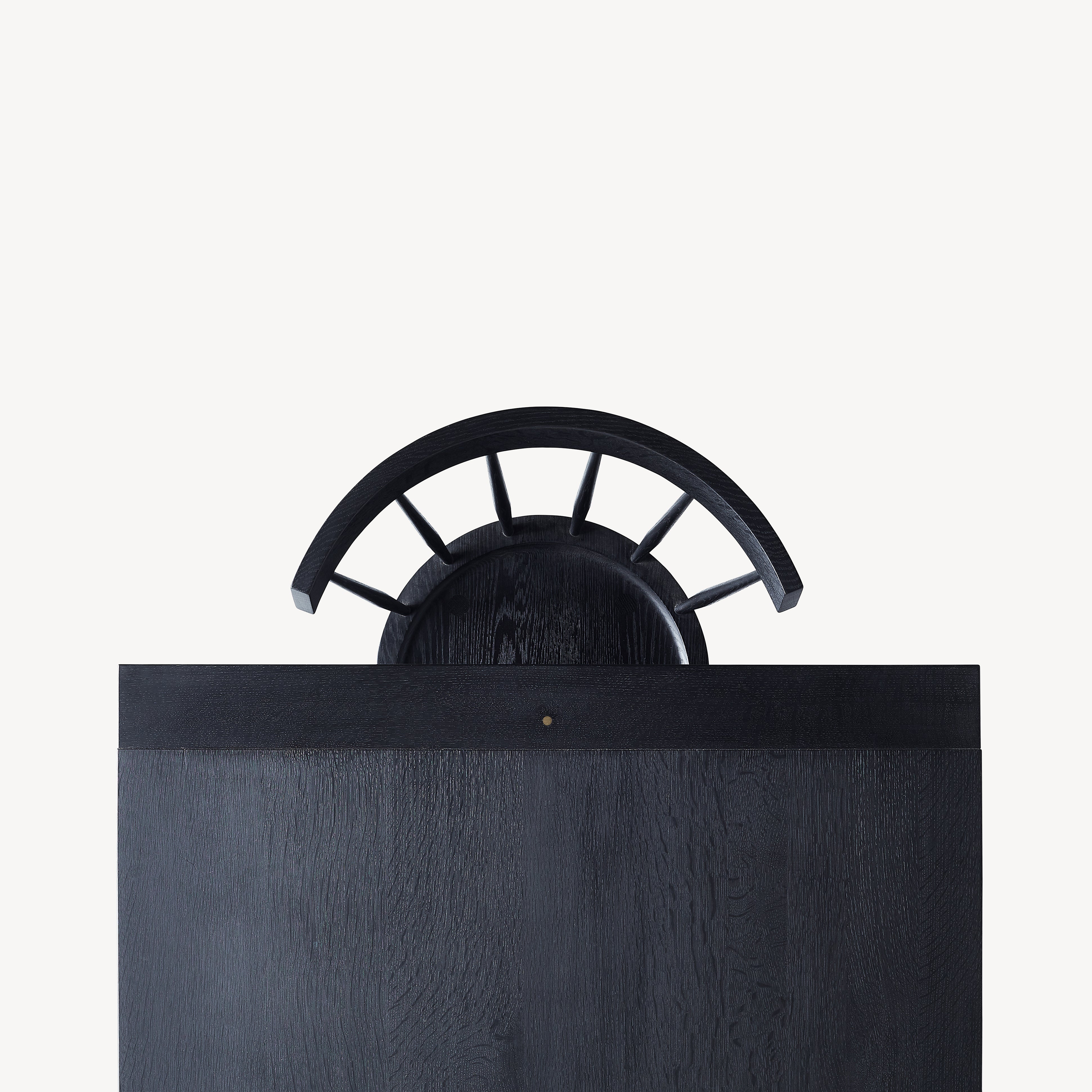 top view of black dining table with a black chair.