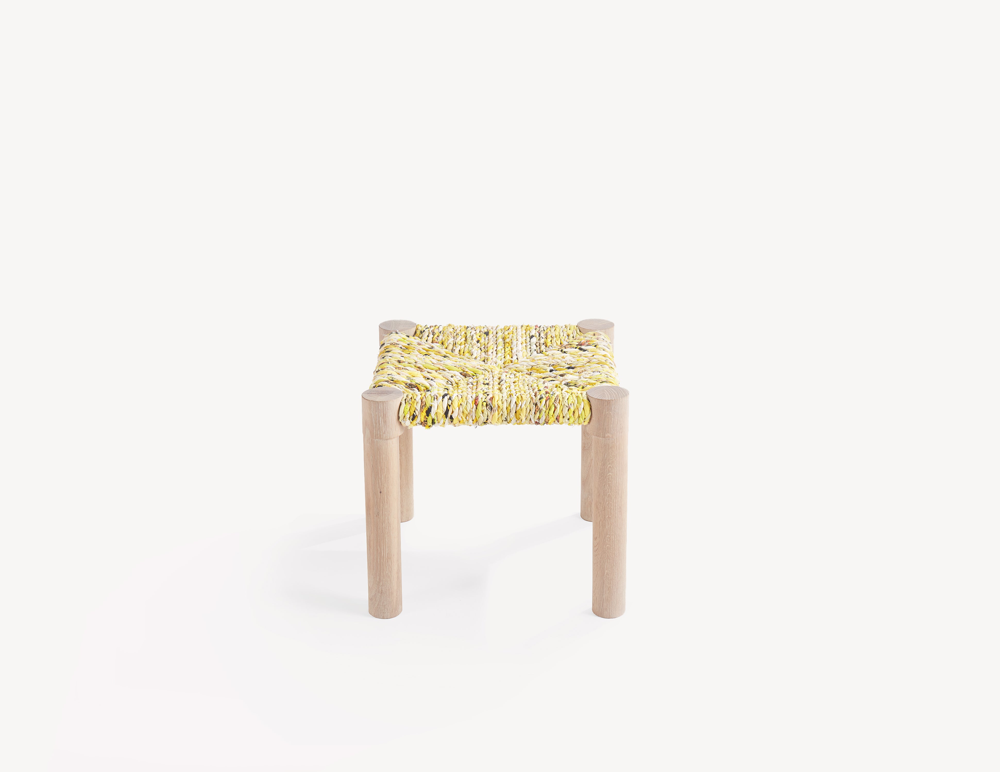 wooden stool with yellow woven seat. high view.