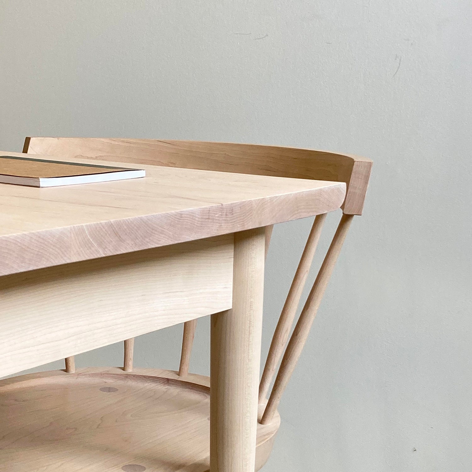 corner view of a light wood desk and chair.