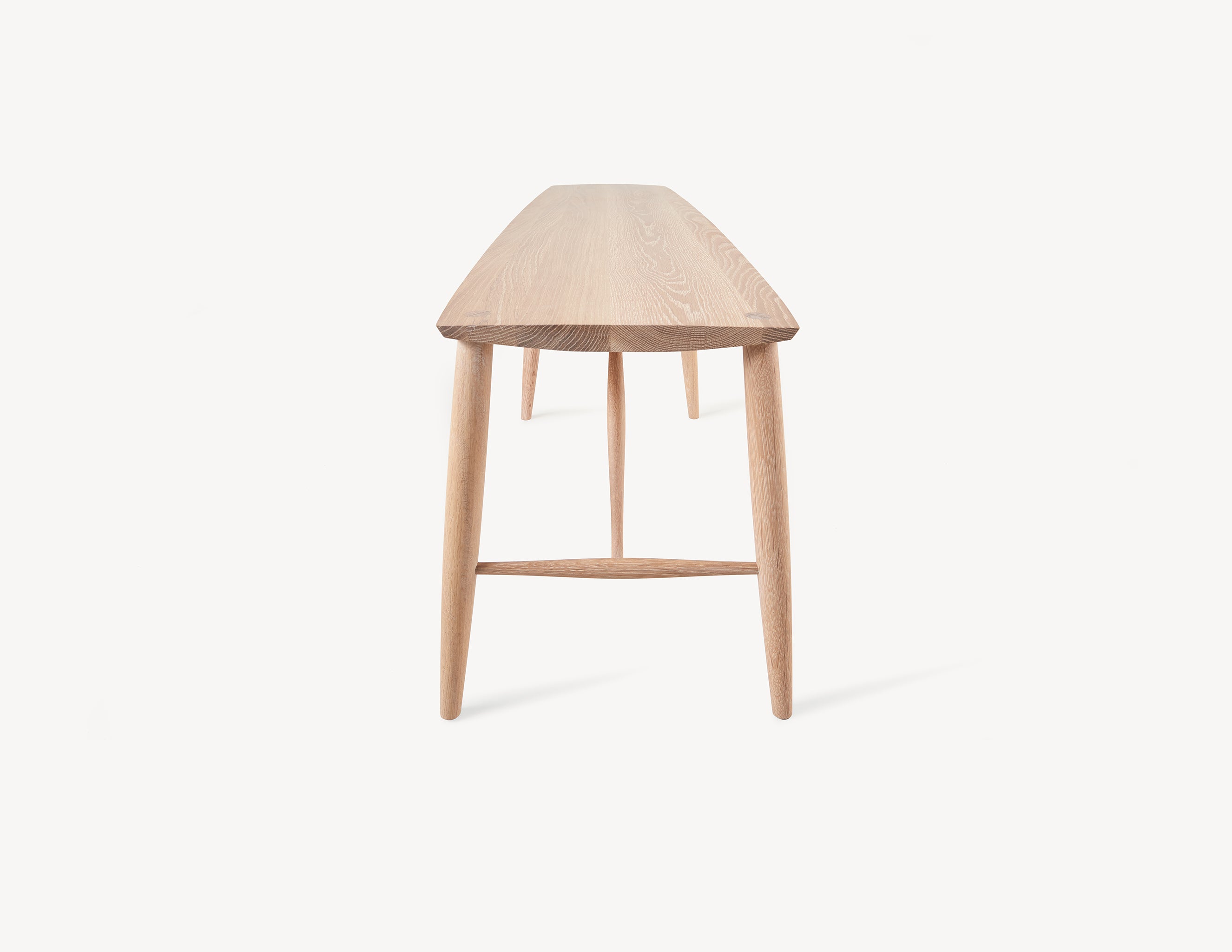 minimal wooden long oak bench in light wood.  end view.