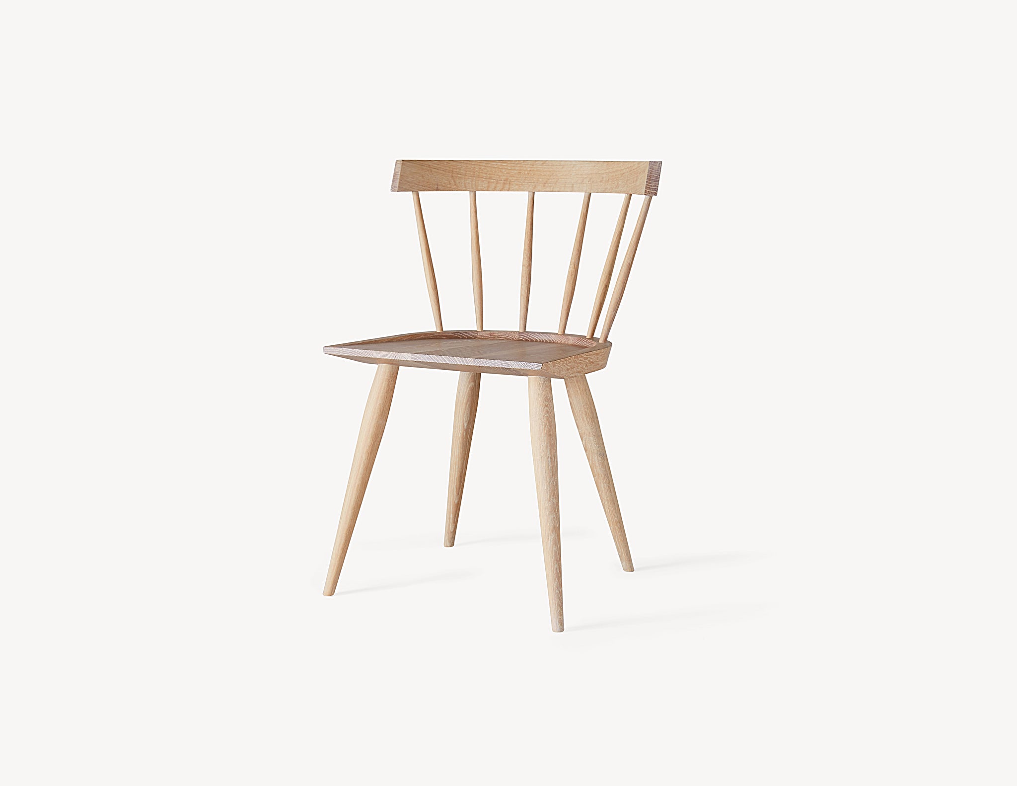 front view of minimal light wood oak windsor dining chair.