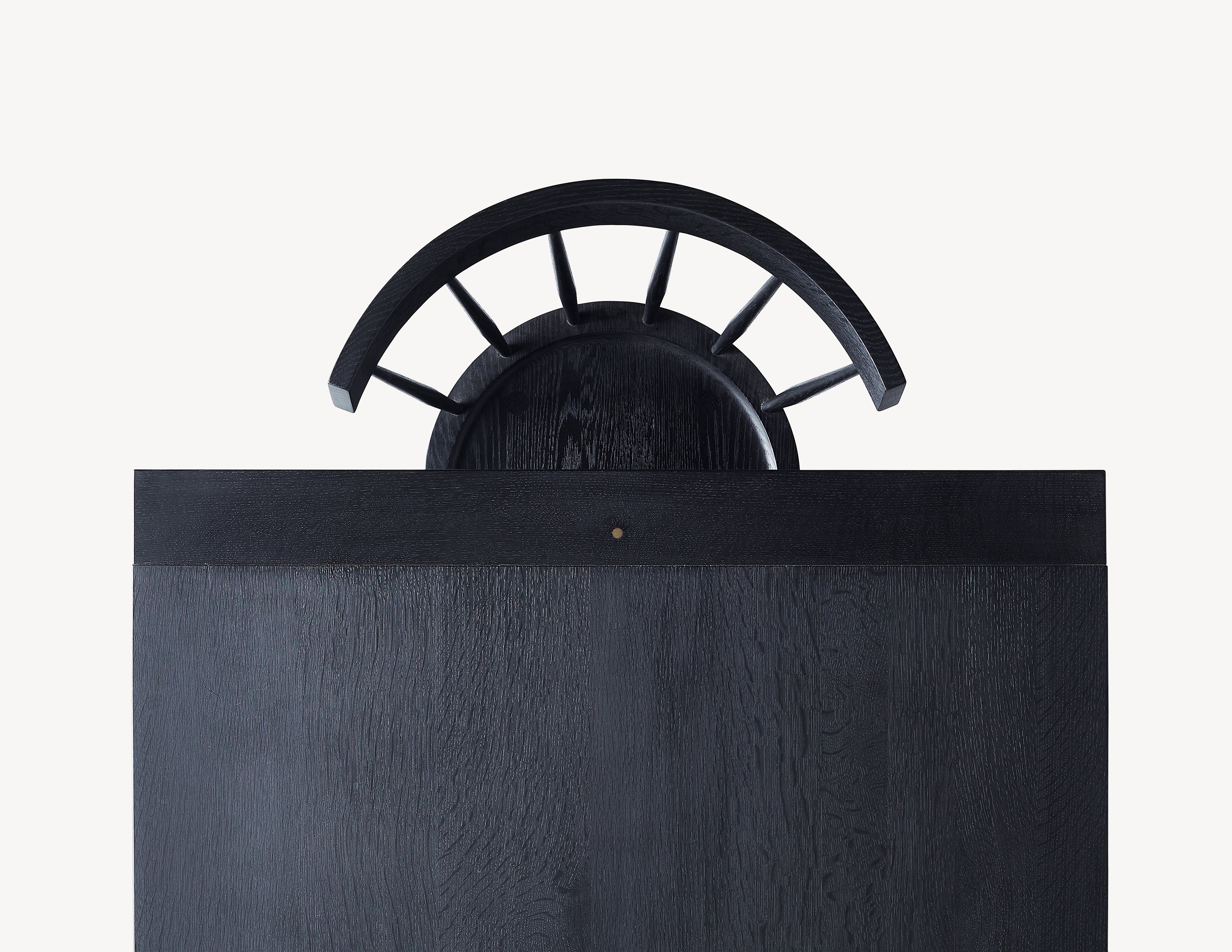 top view of black dining table, with a single black dining chair.