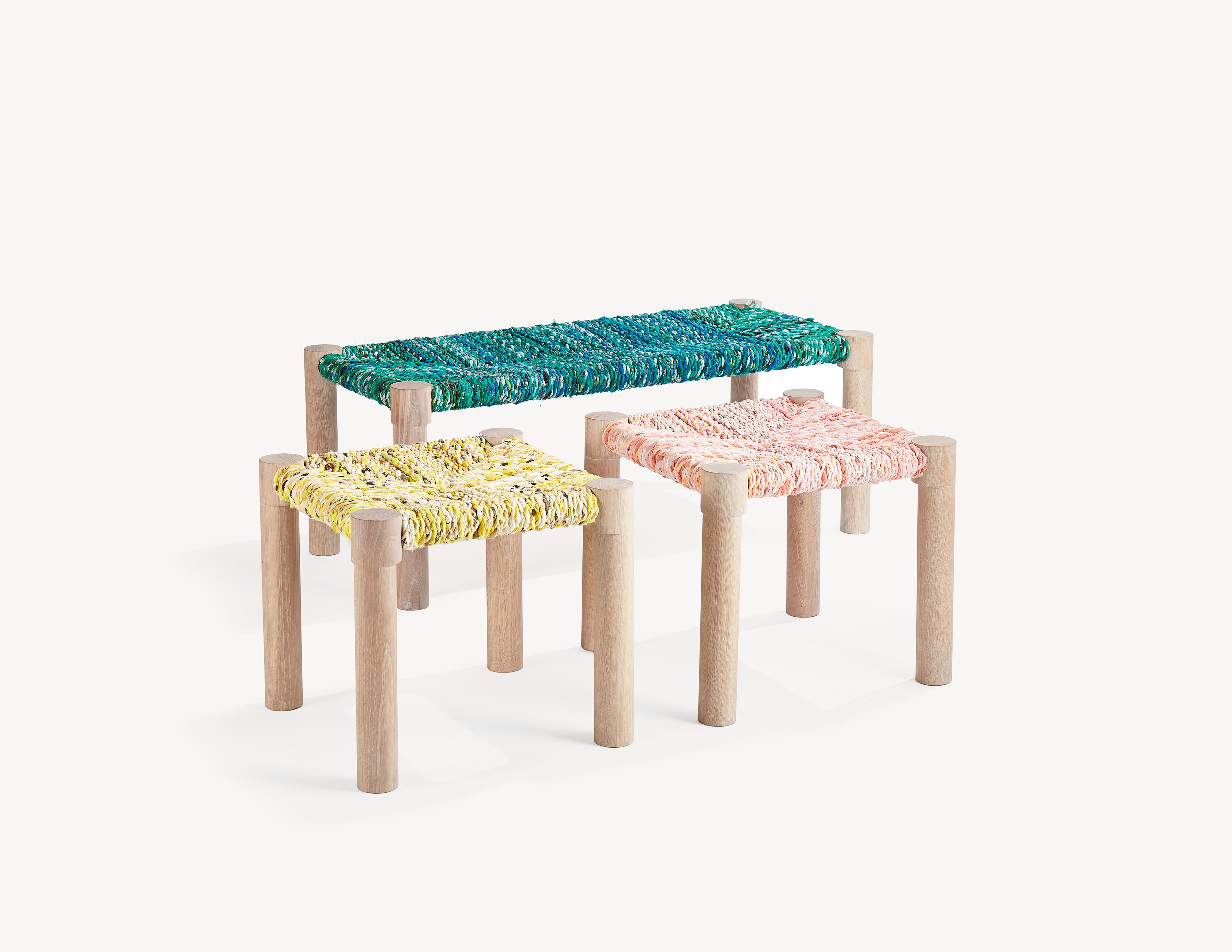 wooden bench and two wooden stools with colourful woven seats.