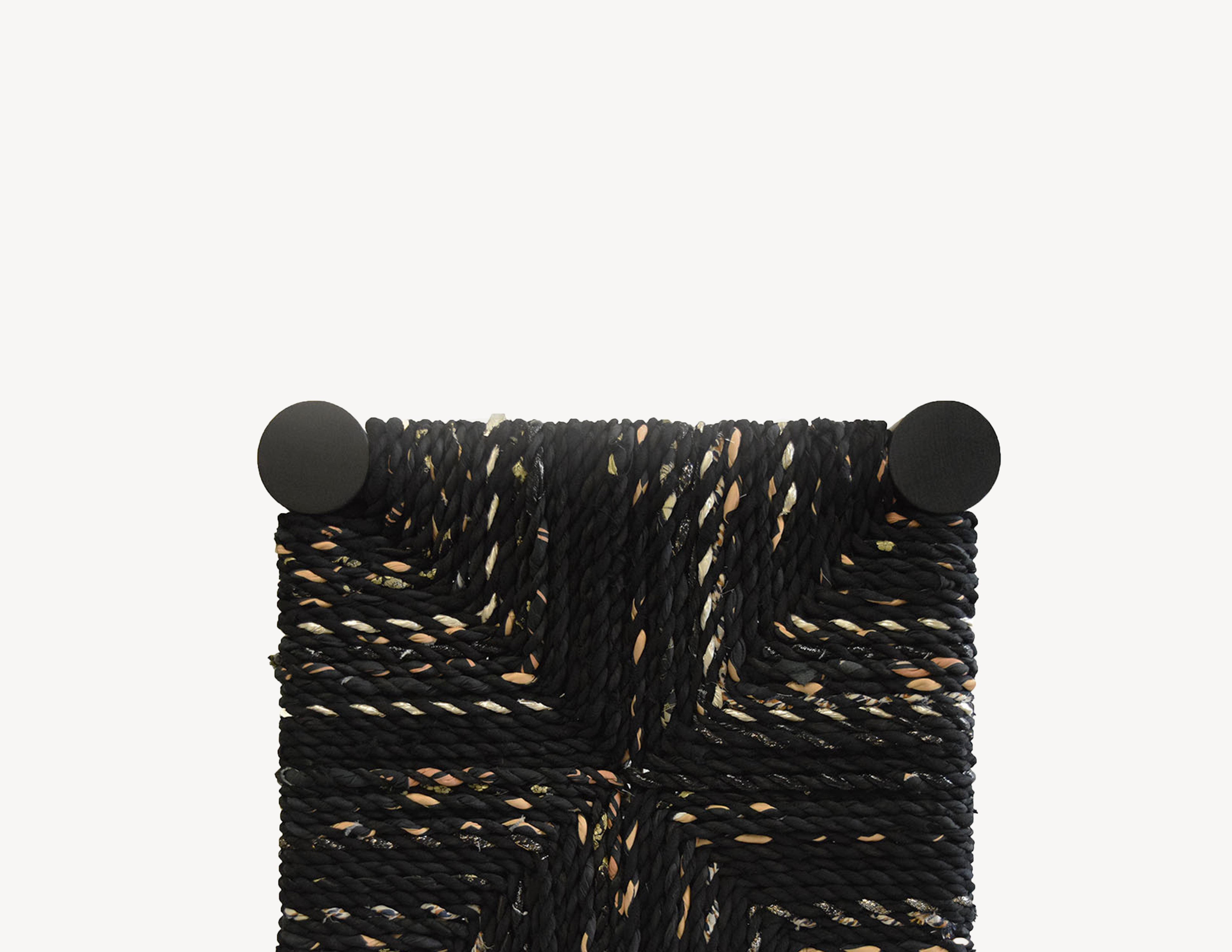 top view of black wooden bench with woven seat.