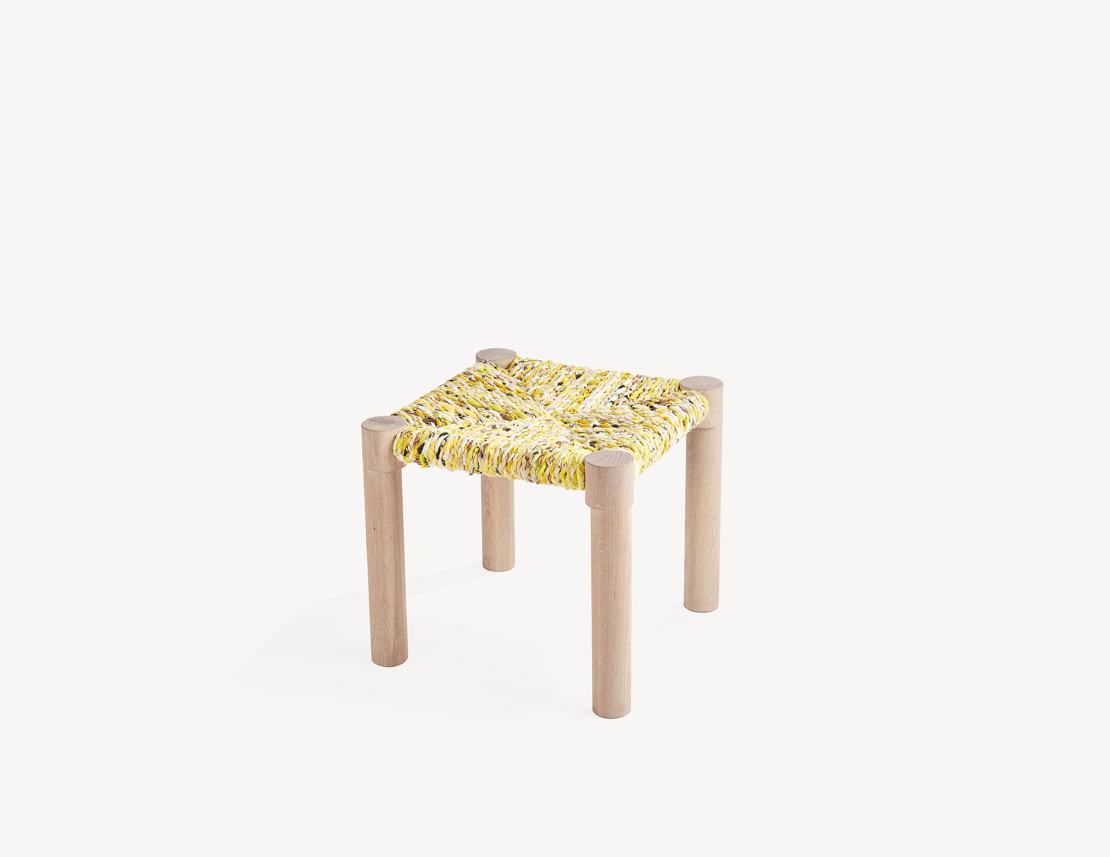 wooden stool with yellow woven seat.